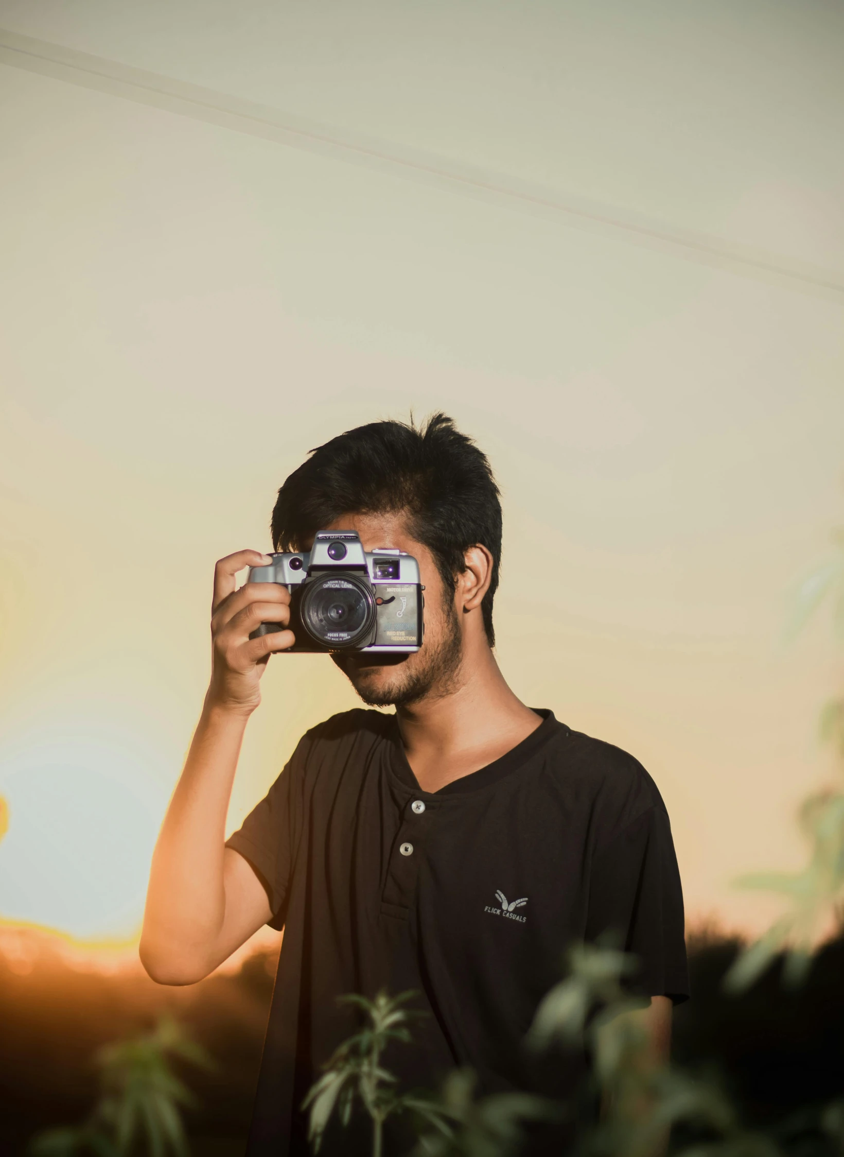 a man is holding up a camera to take a po