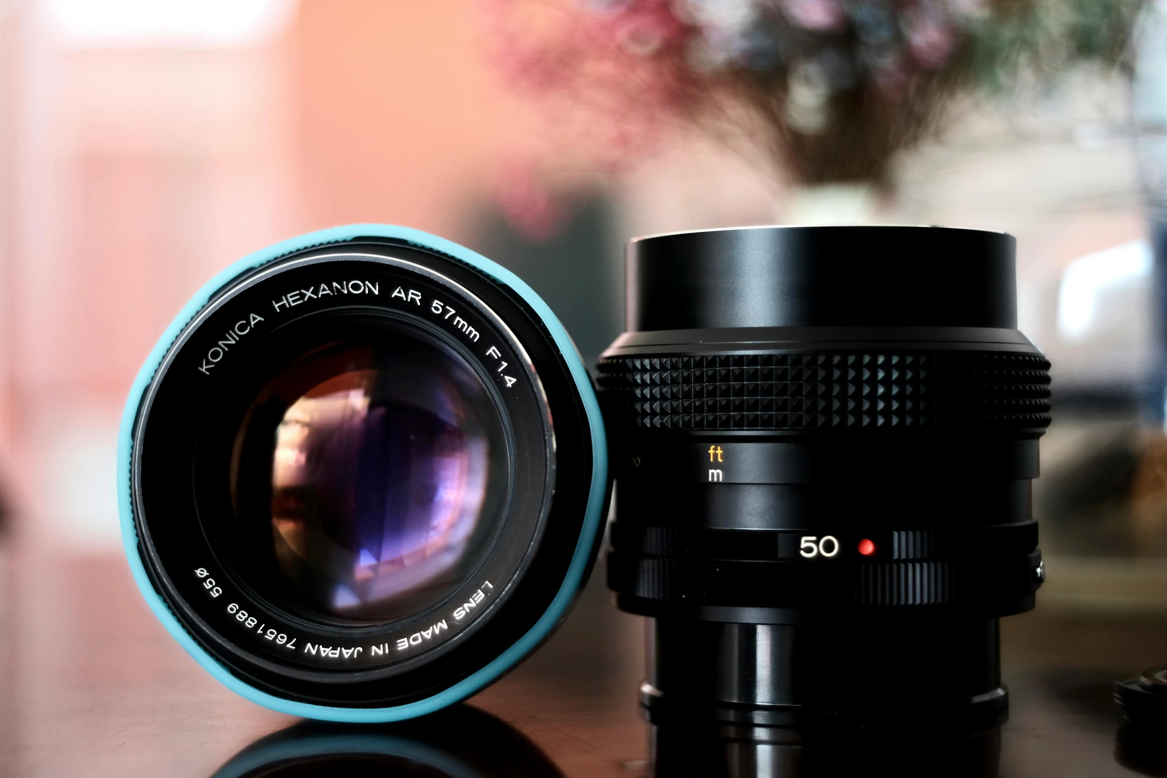 a camera and lens cap on a wooden table