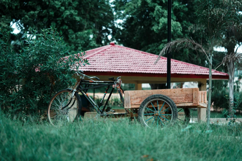 the bike is parked next to a wooden cart