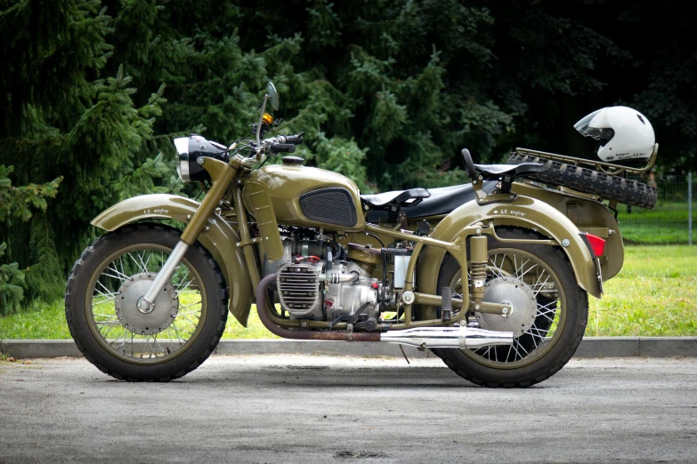 an antique military motorcycle parked on the street