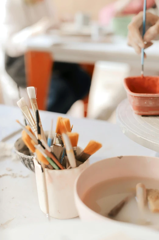 a cup with tooth brushes sitting in it