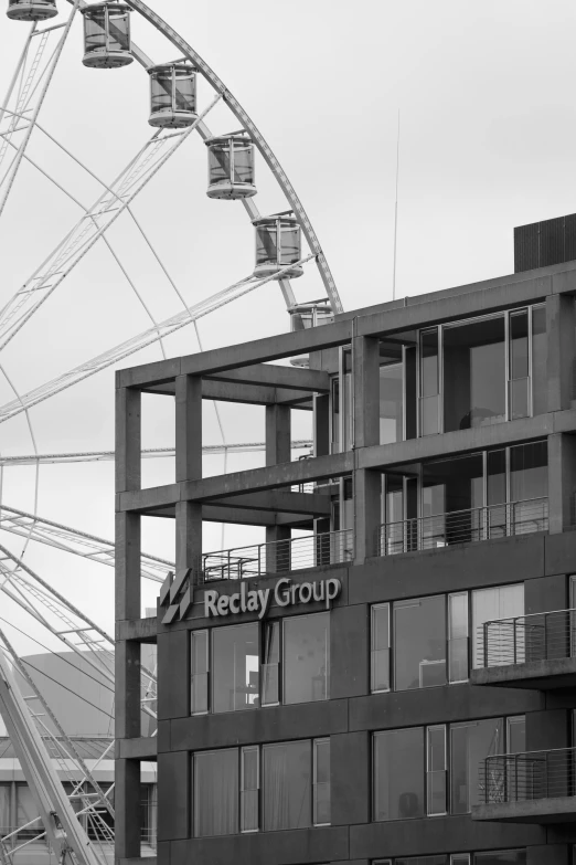 an amut park ferris wheel that is next to a building