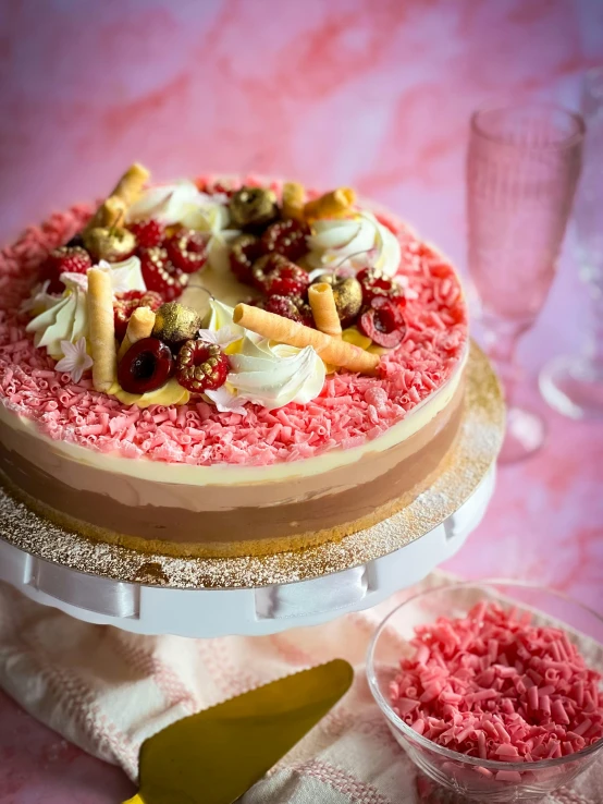 a small chocolate cake with white and pink icing