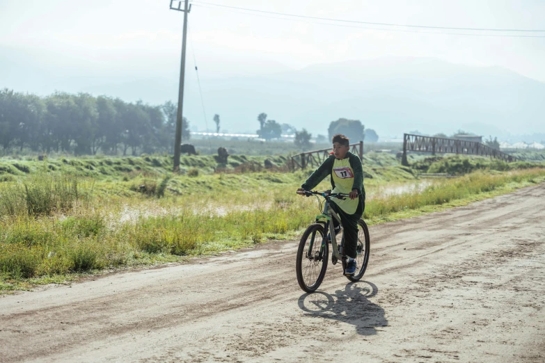 a man rides his bike down the road