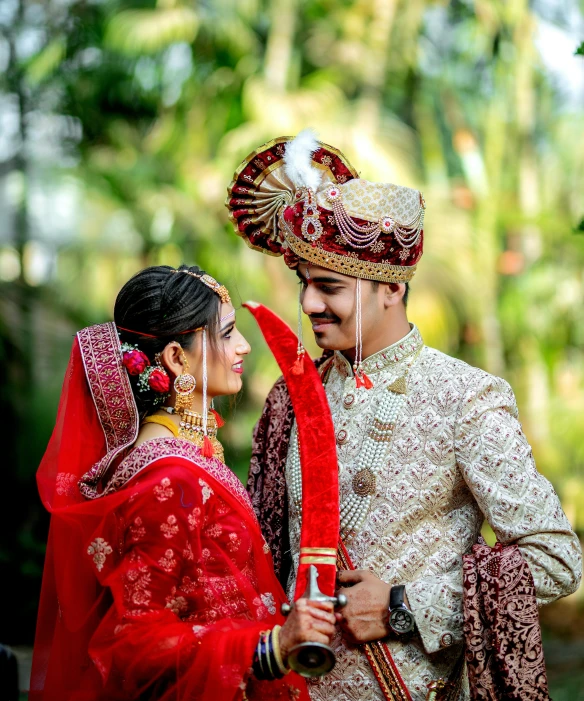 a man and woman in indian garb looking at each other