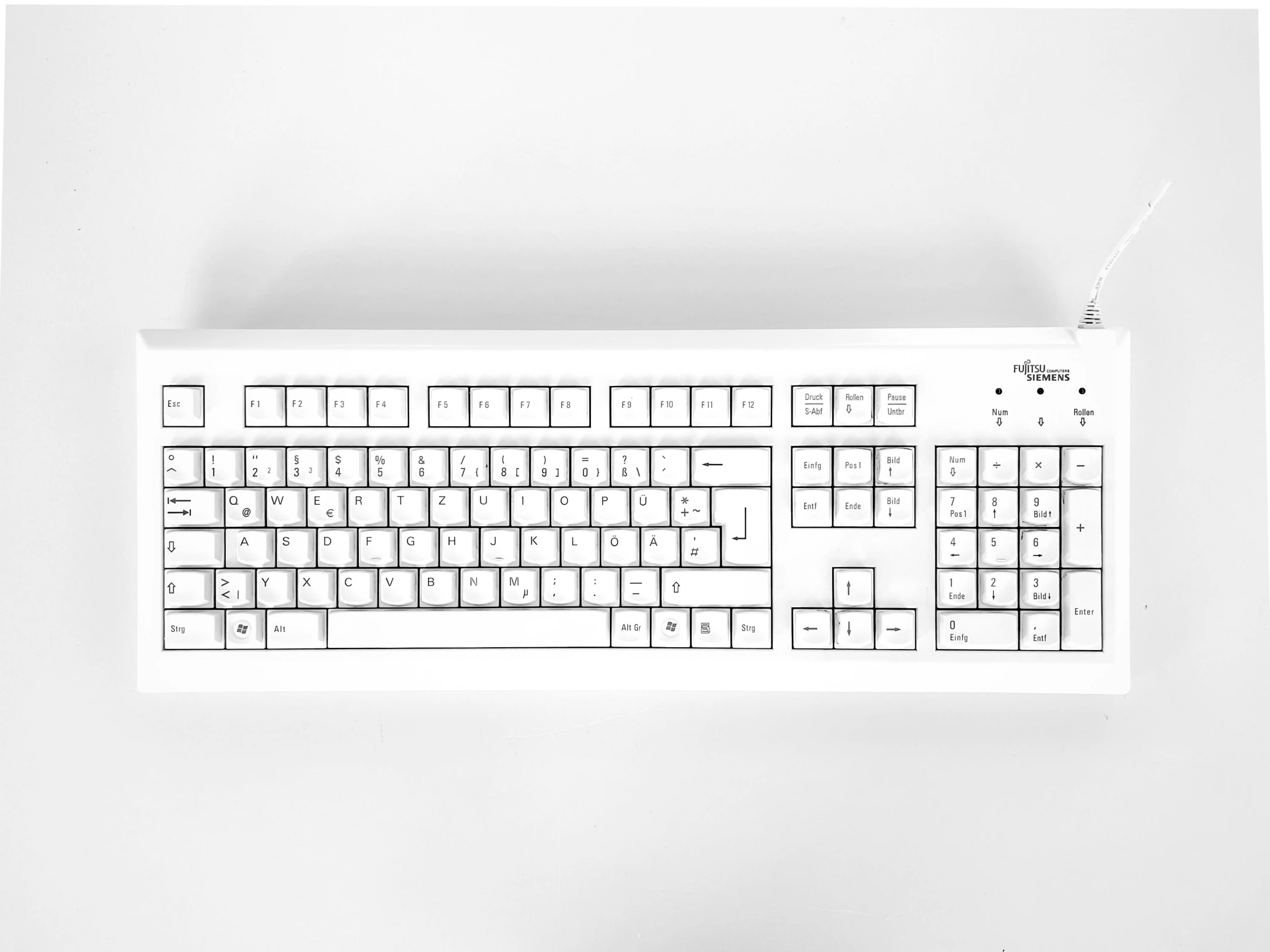 an image of a keyboard on top of a white desk