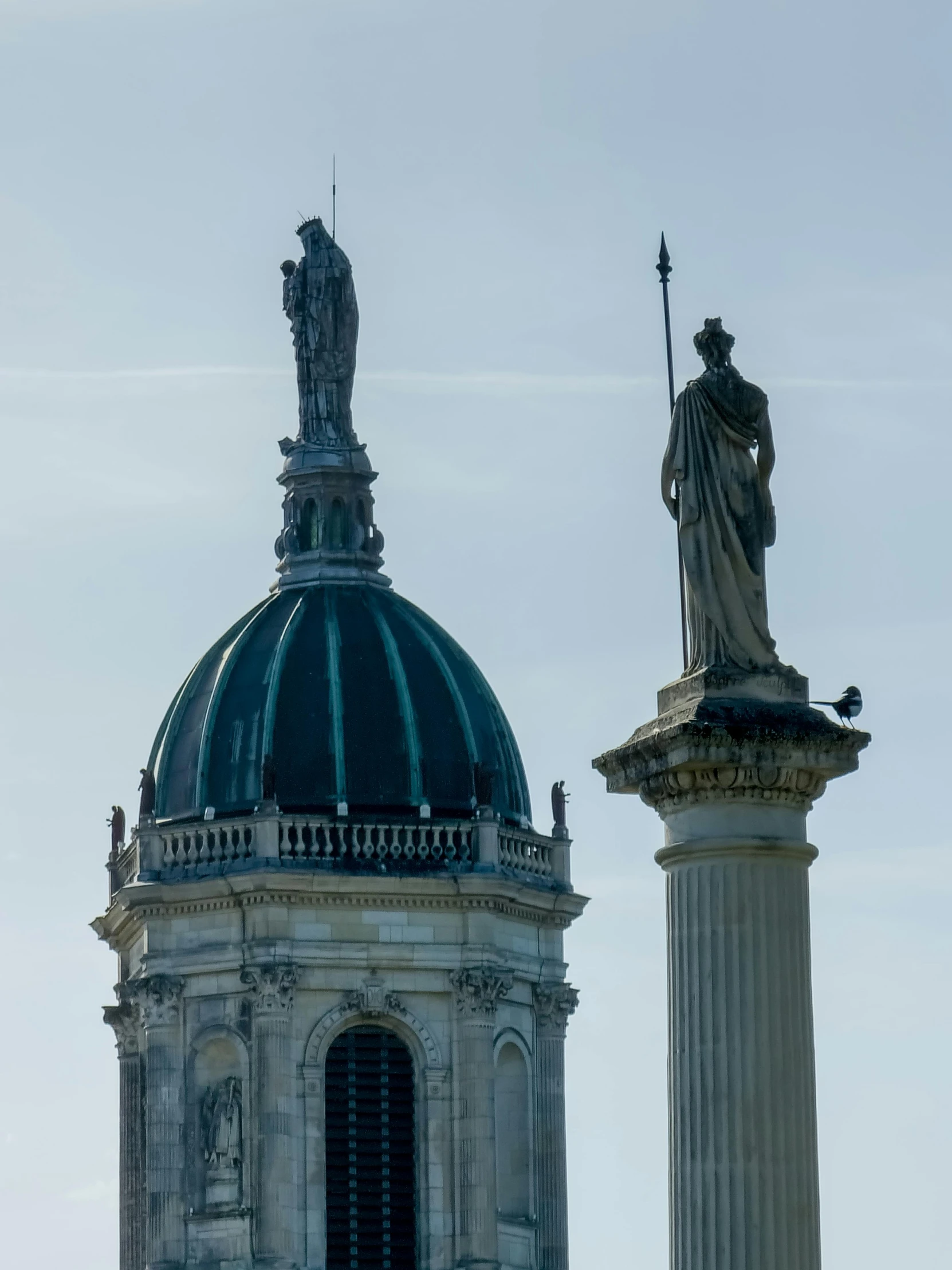 an ornately styled building with statues on top