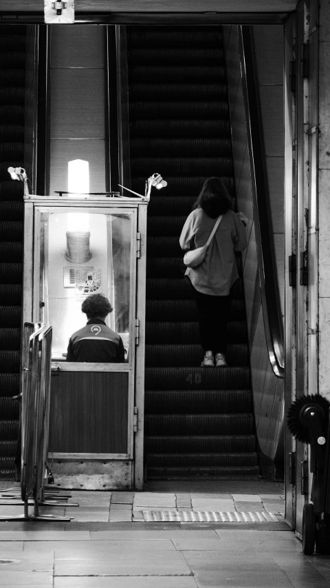 an escalator with a person sitting in it at night