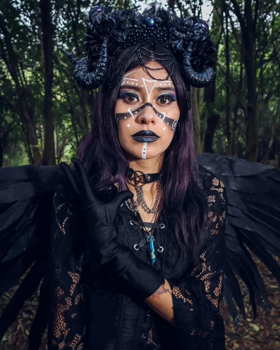 woman wearing black with wings painted on her face