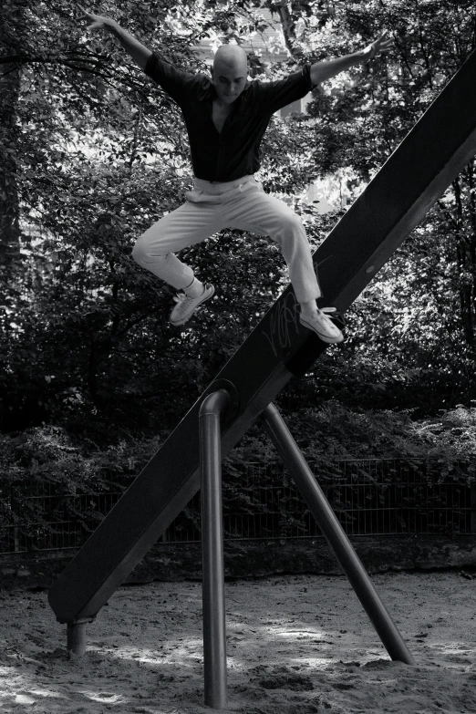 a person that is jumping over a swing