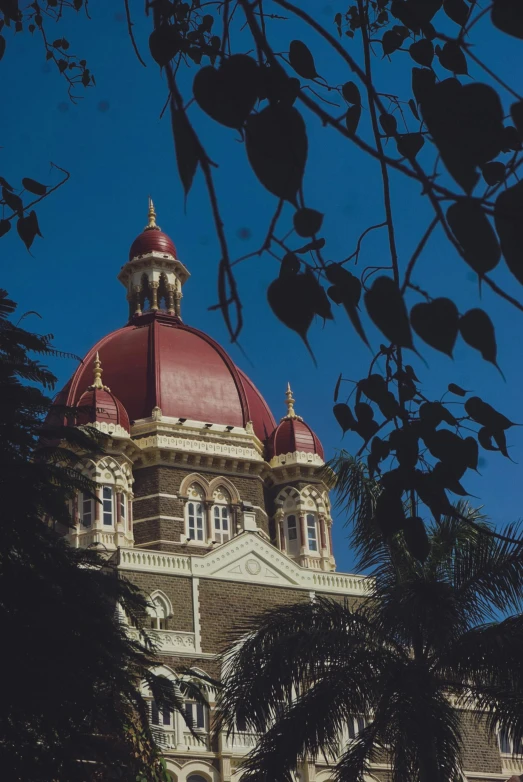 an old building is shown with trees near by