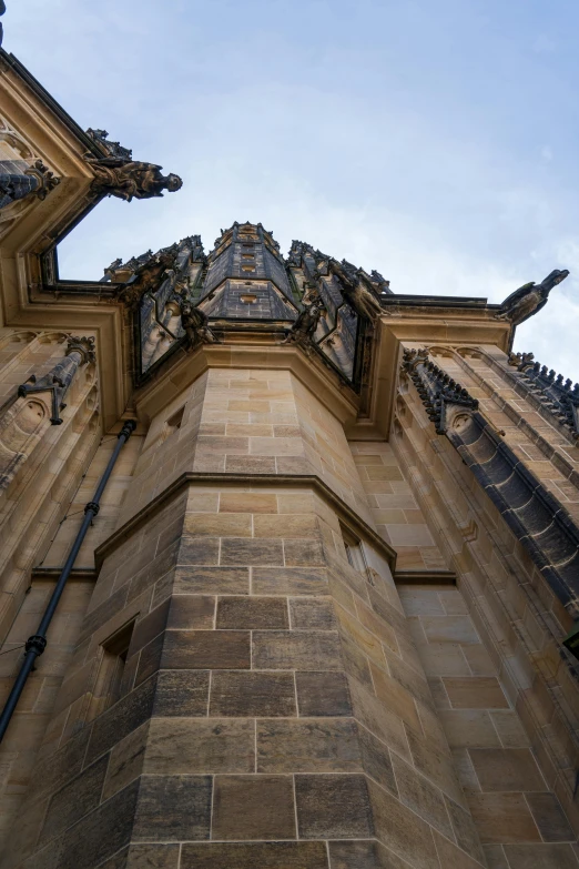 an upward view looking up at the roof and walls of a building