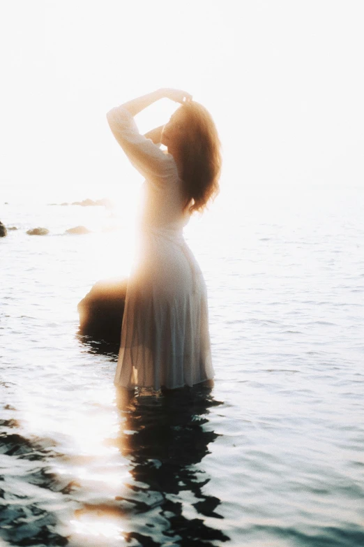 a woman standing on top of a body of water