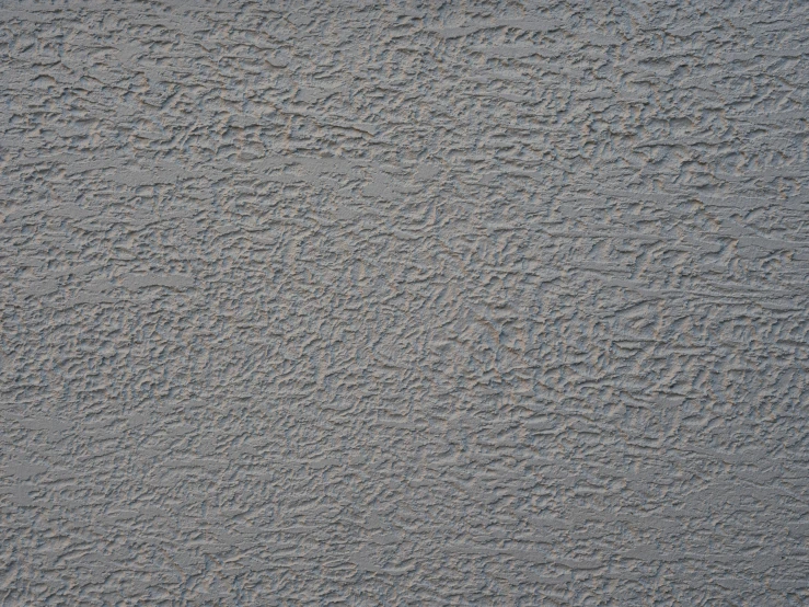 a wall made out of sand with a white frisbee