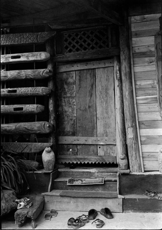 an old wooden door and shoes are outside