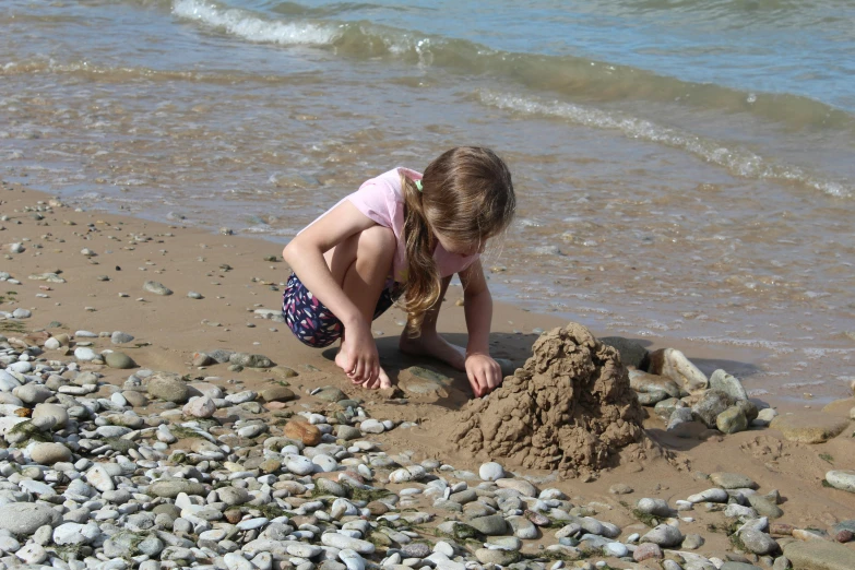 a  playing with a sandcastle on the beach