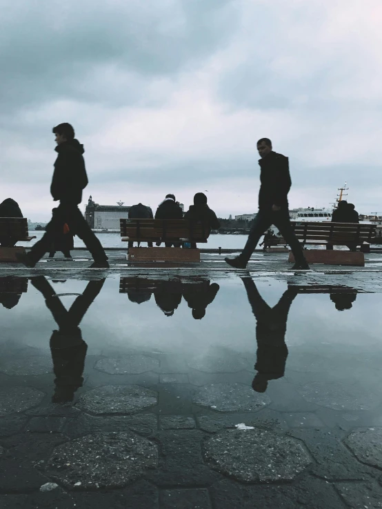 people walking in the rain with their luggage