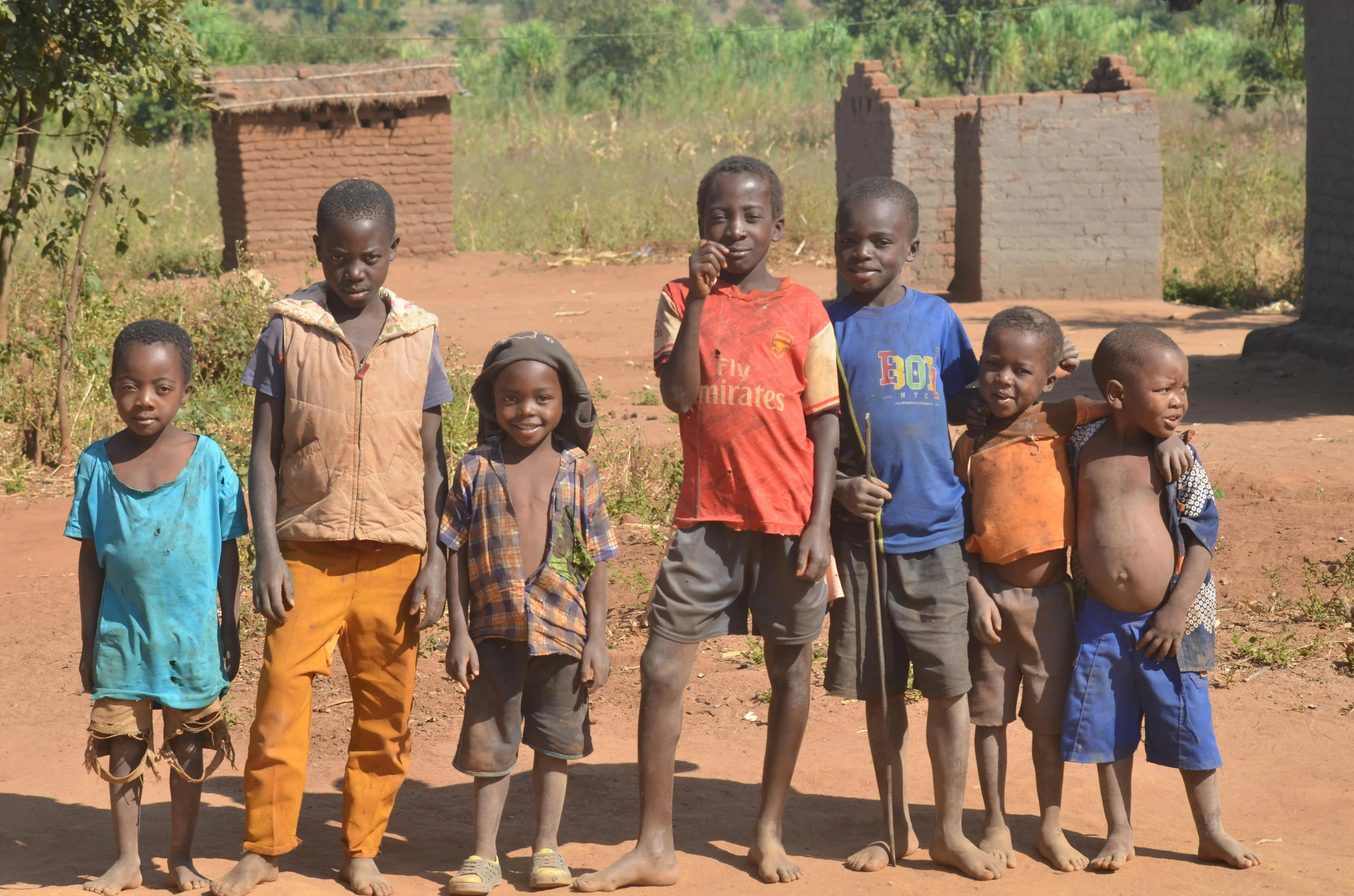 several children posing for a po in the country