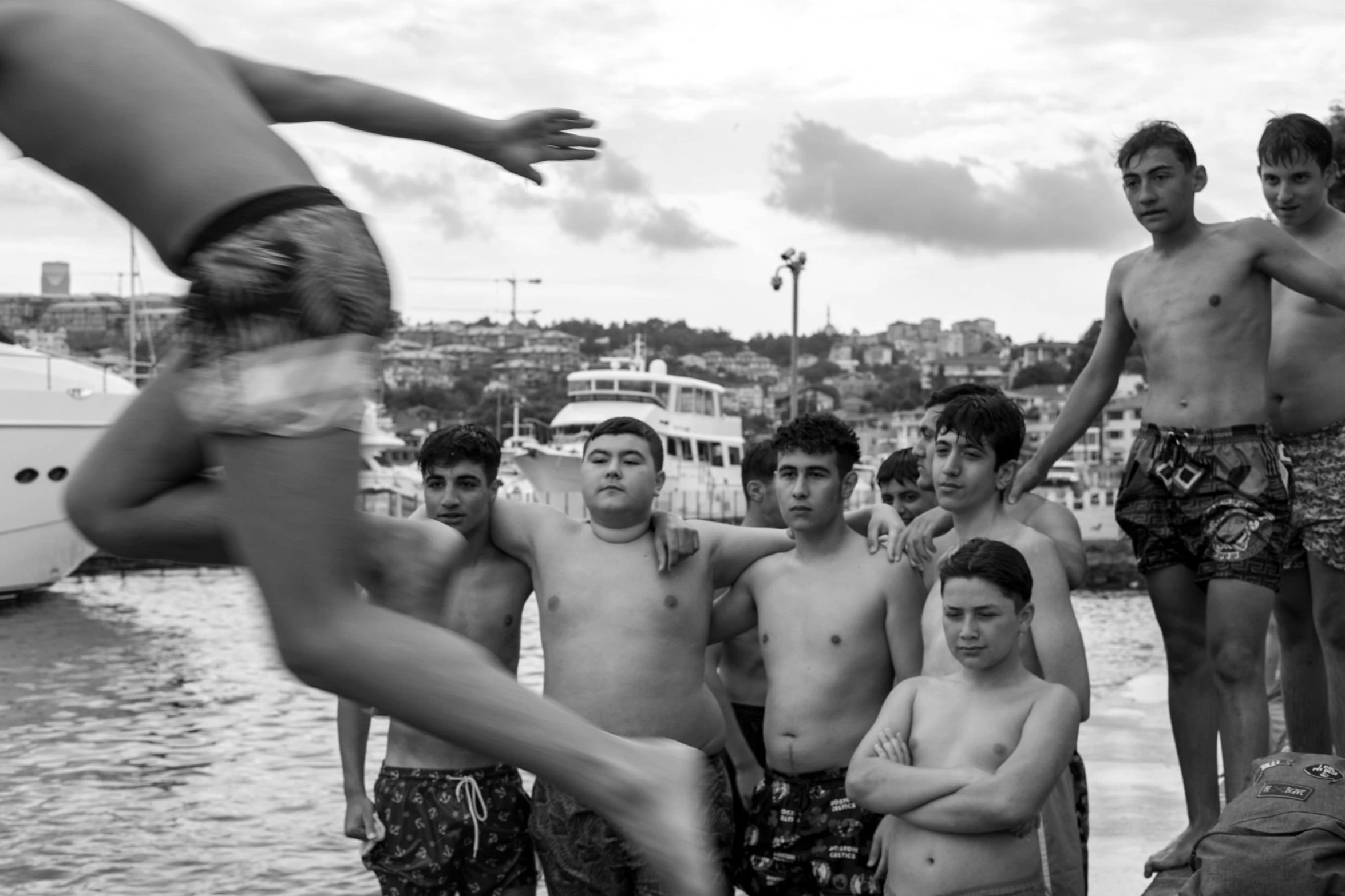 a group of people standing around a body of water