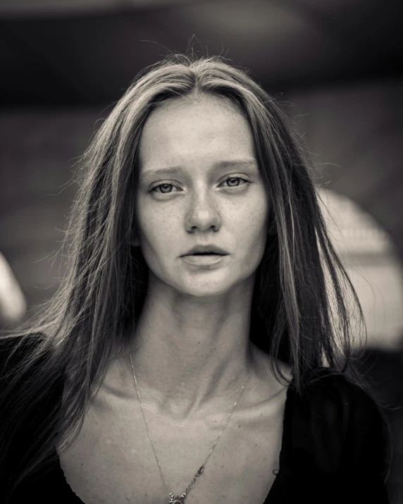 a woman with long hair standing in the street