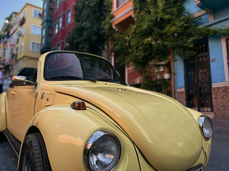 yellow vw bug parked in a narrow city alley