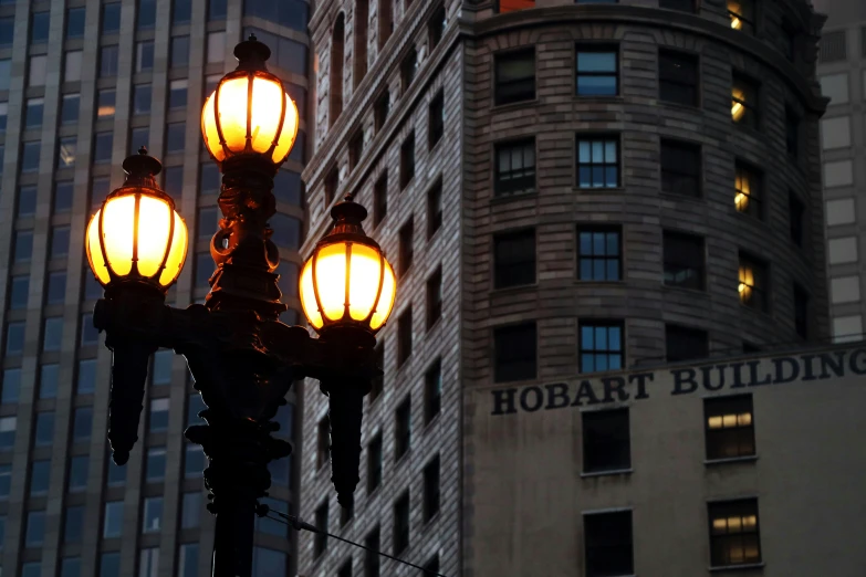 two street lamps lit up in the city