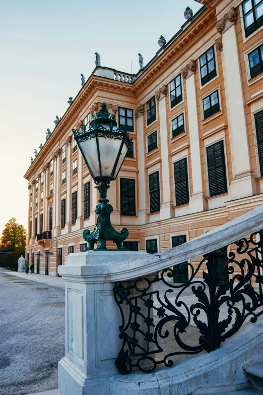 a fancy stone and iron balcony with a wrought iron fence near a building