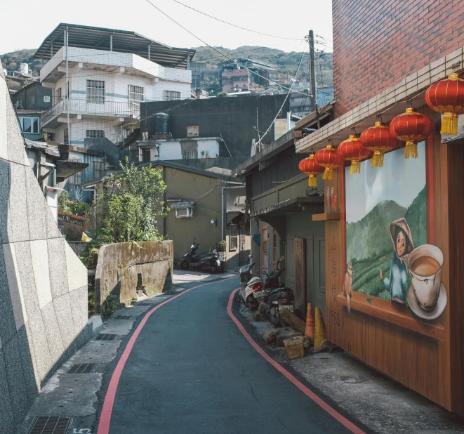 a street with buildings and pictures on the walls