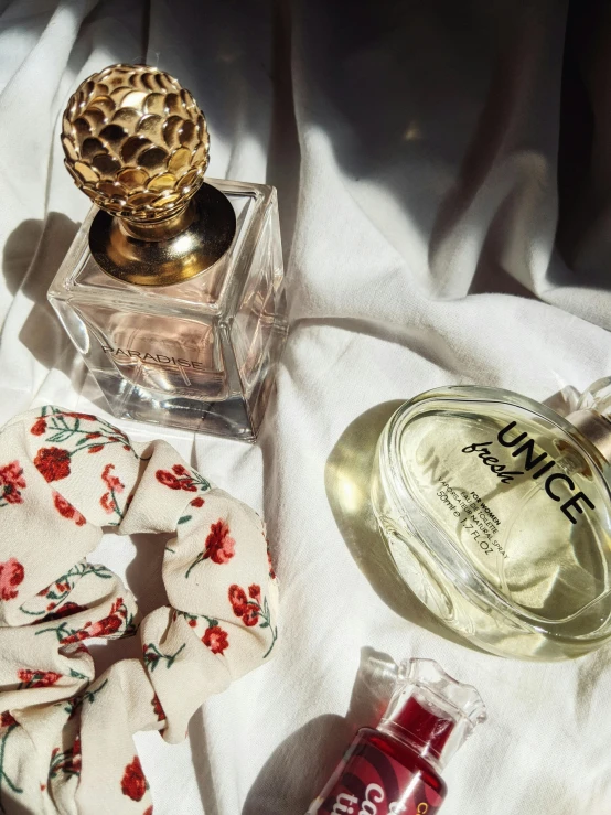 a bottle of perfume sitting next to a cloth