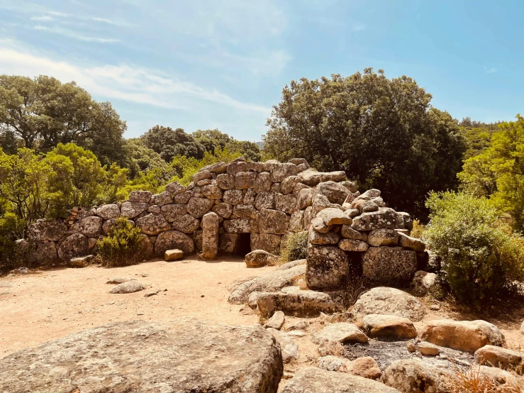 some rocks and bushes near some large boulders