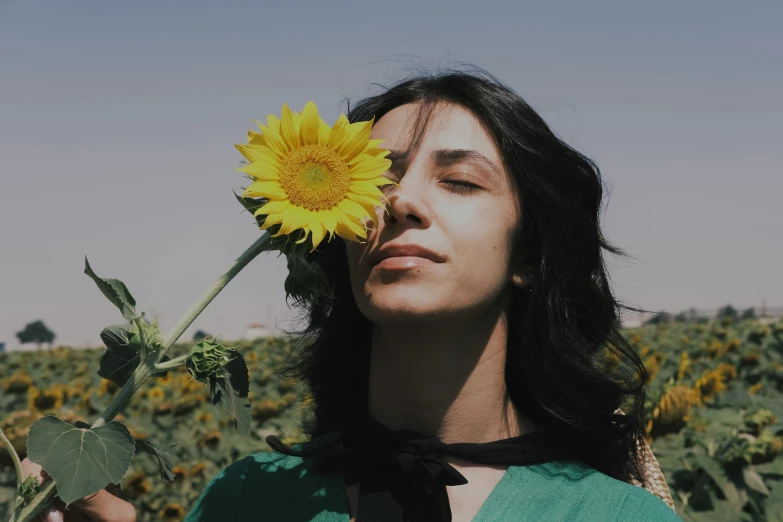 a woman with a sunflower in her hair