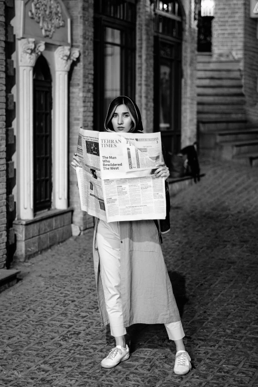 a woman holding up a newspaper in front of her