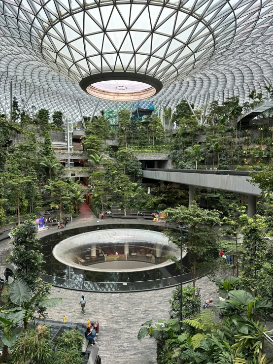 a huge building with several atriums and trees