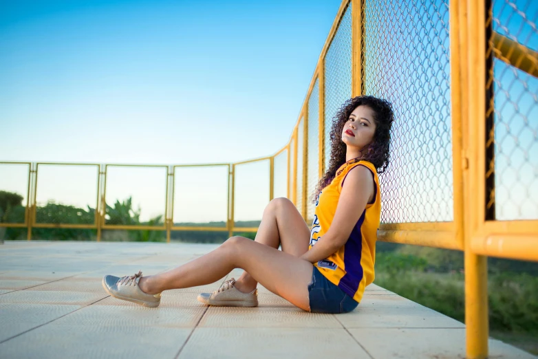 a woman is sitting down on the cement