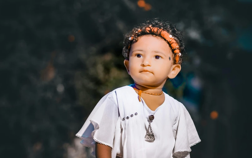 small child with an orange mohawk standing