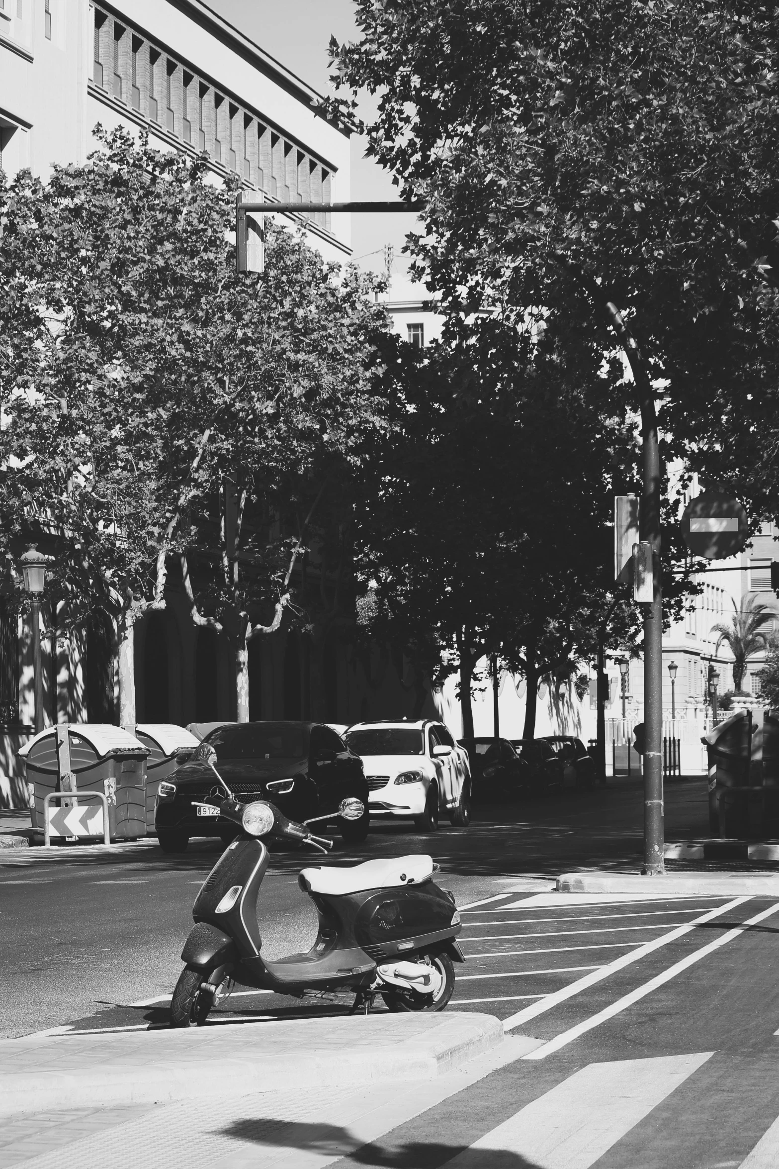 an old - fashioned moped waits at a curb in the city