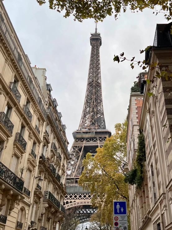 the view of the eiffel tower from between two buildings