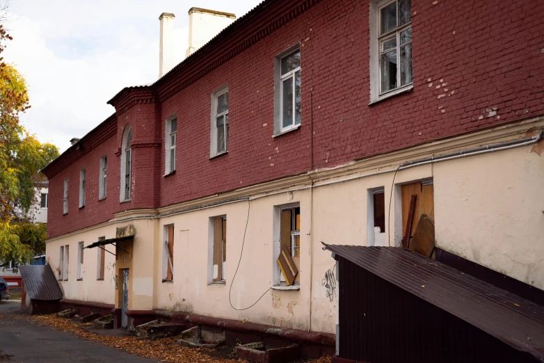 the side of the building has broken windows