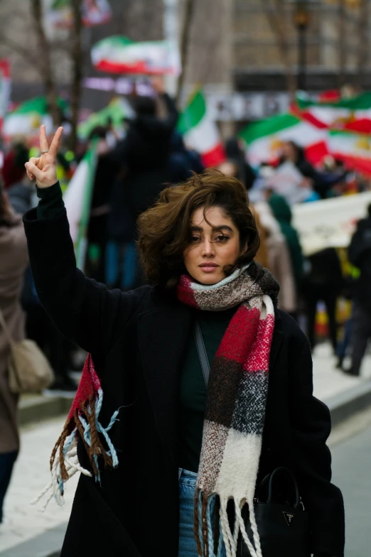 a woman standing in the middle of a crowded street