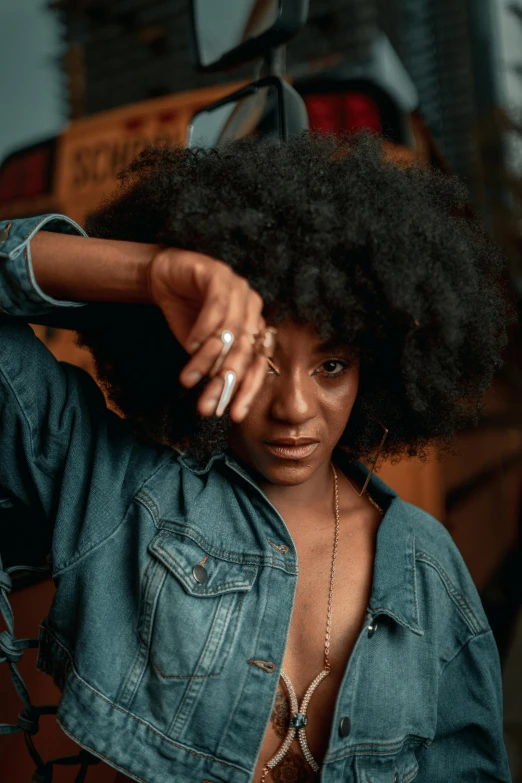 woman with large afro standing near an object