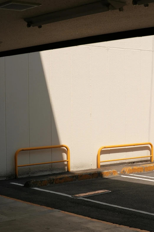 two benches against a wall near the road