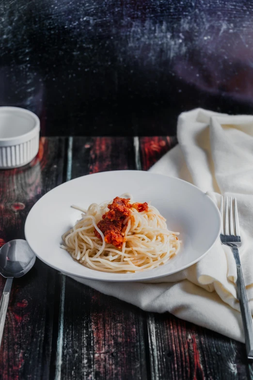 a white plate with a spaghetti dish on top