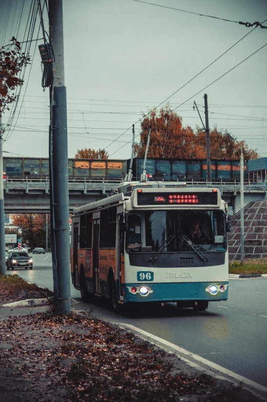 a bus traveling on the road with an overhead view of buildings and a highway