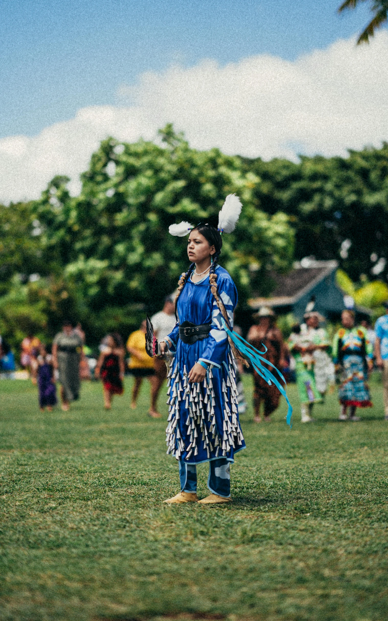 a person in a grass field with people watching