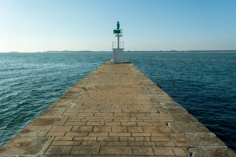 an old jetty with the sea in the background