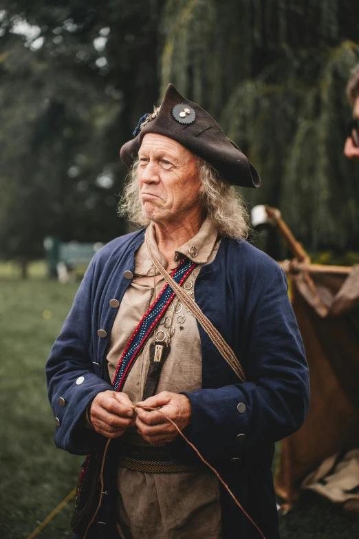 an old man in uniform with a sword and some other items