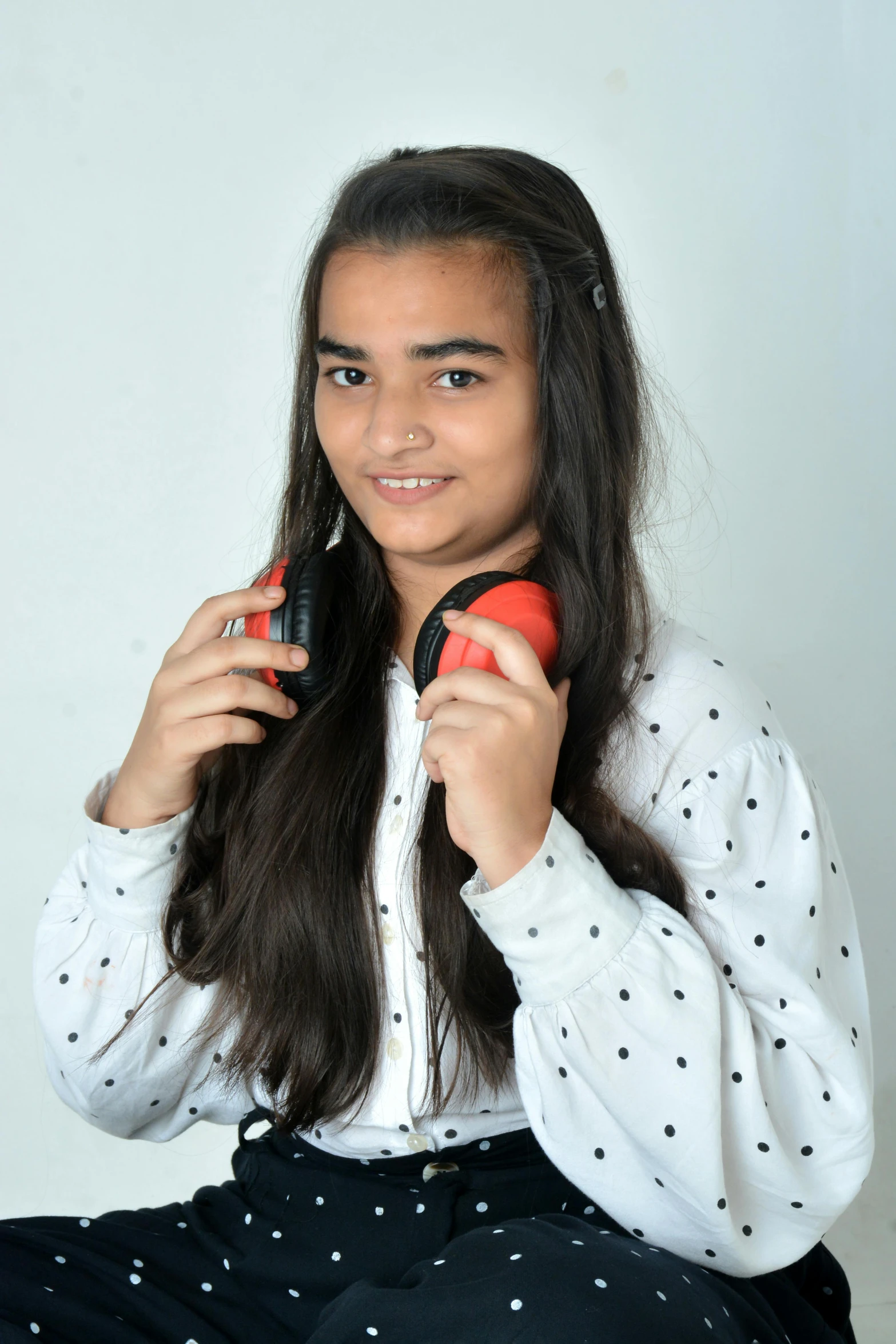 a  blow drying her hair with a red and black comb