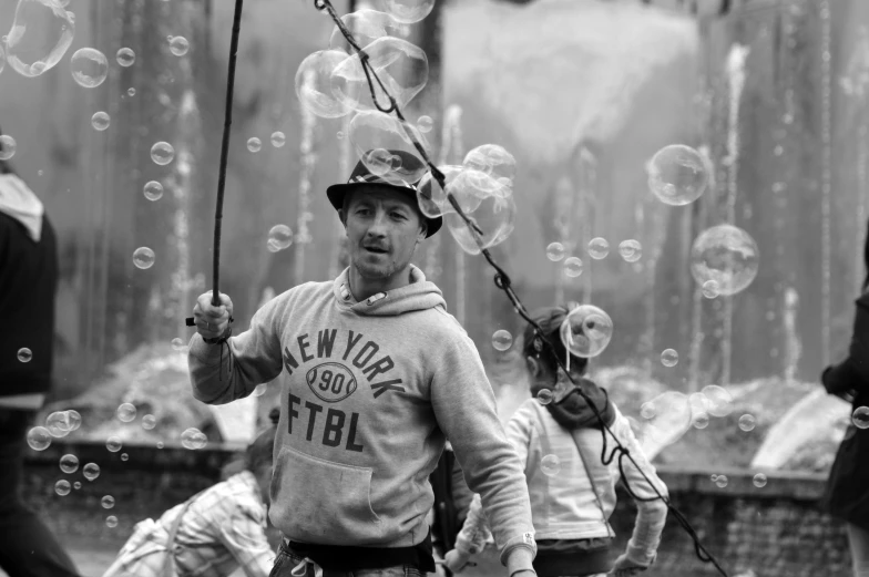 an old black and white po shows people blowing bubbles