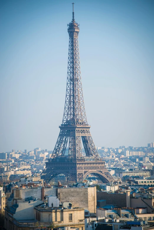 the eiffel tower is standing in front of buildings