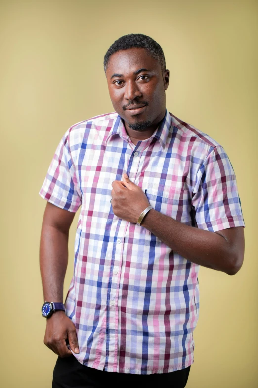 a man posing for the camera in plaid shirt